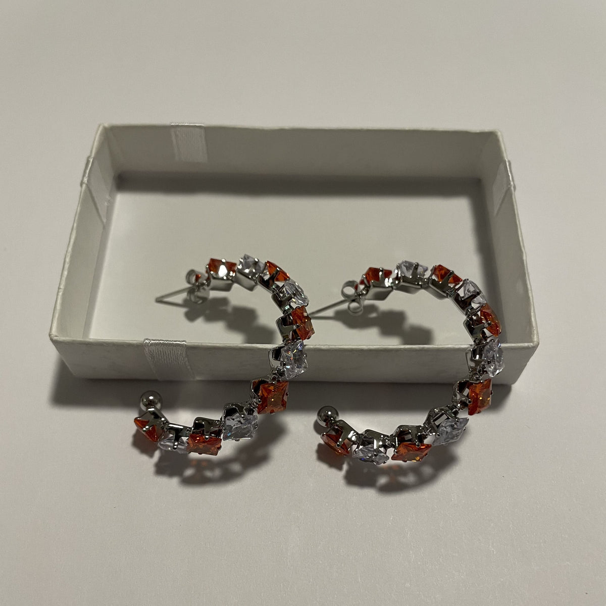 Boucles d'oreilles créoles rouges et blanches avec détails argentés