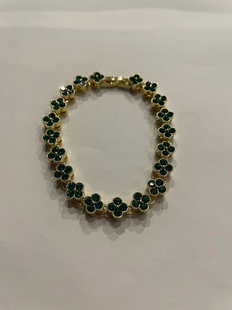 Bracelet de couleur dorée composé de trèfles verts scintillants